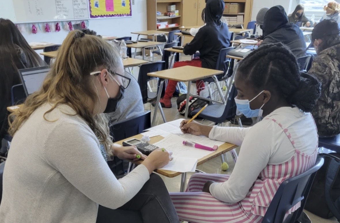 A tutor helping a student with their schoolwork